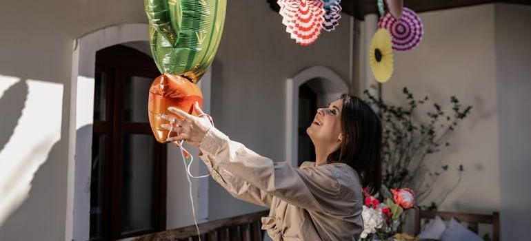 a woman holding balloons knows why every event planner should invest in portable storage