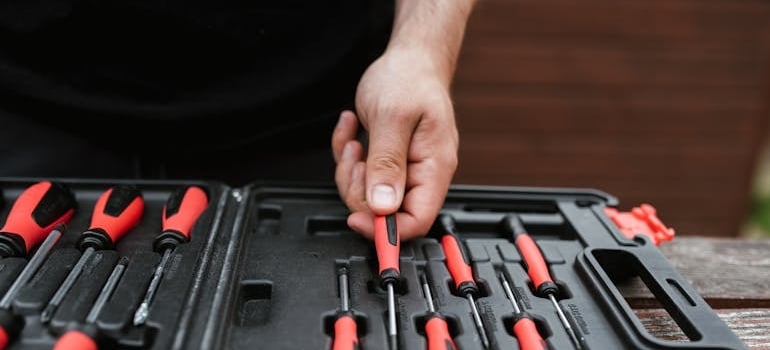 a man organizing screwdrivers in a toolbox in order to upgrade jobsite storage