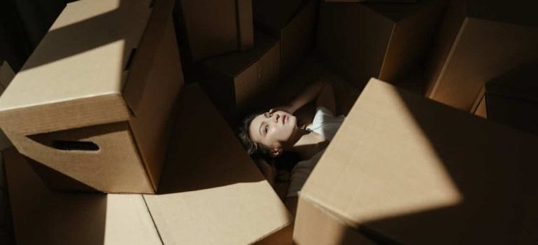 woman among boxes before putting them into storage units Breckenridge CO