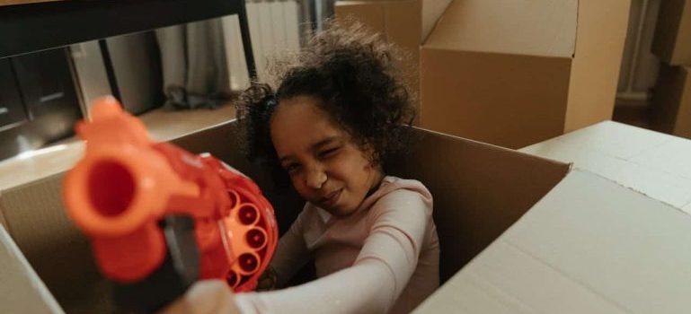 girl playing in a box