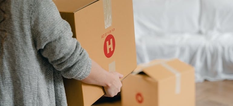 a woman carrying boxes