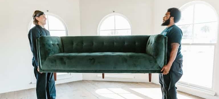 movers carrying a couch providing warehouse receiving services
