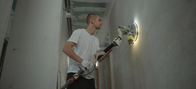 Man doing restoration on a wall.