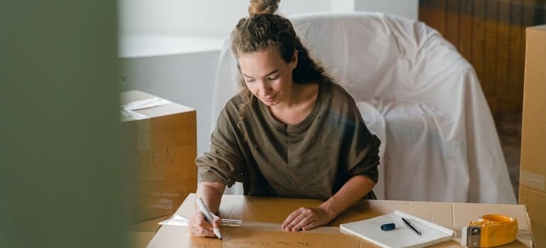 a women labeling boxes