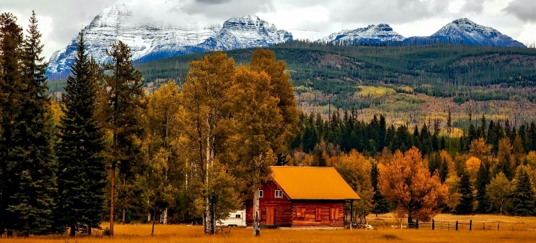 A Colorado cabin surrounded by fall colors and snow-dusted mountains