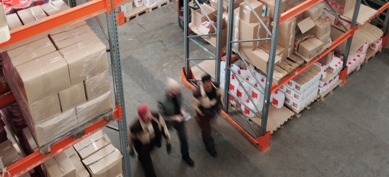 People in the warehouse talking about How to Choose the Right Warehousing Solution for Your Business Needs