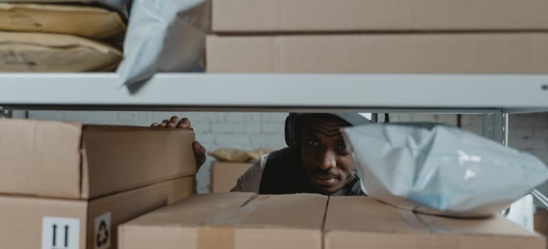 a man inspecting a storage unit