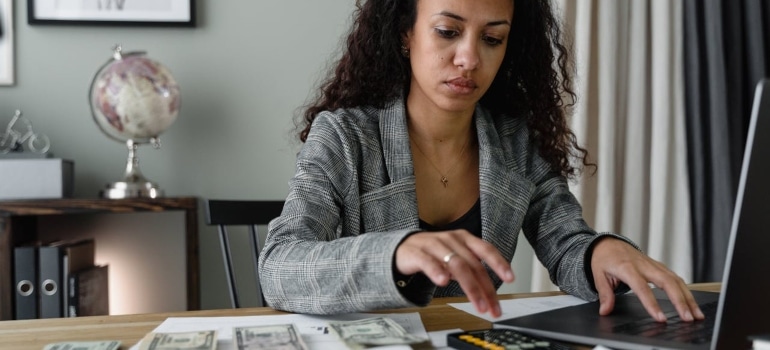 a woman calculating the cost of living in Colorado
