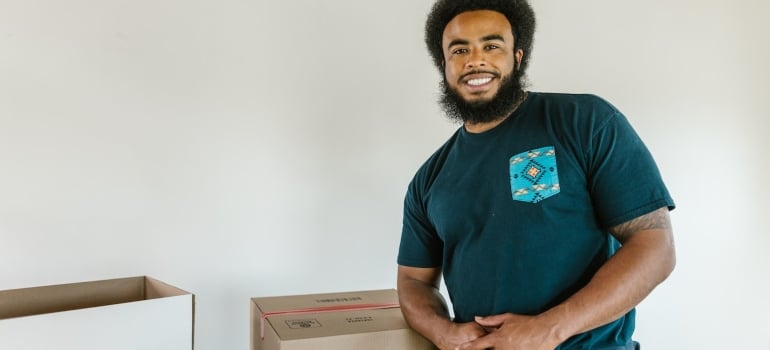 a mover standing next to a box