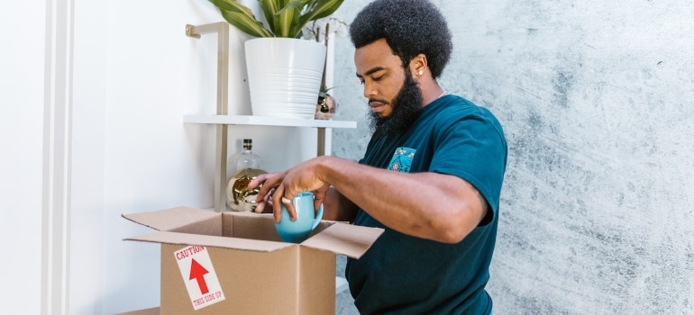 one of the movers Aspen CO packing a mug