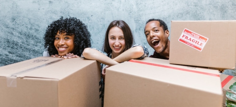 happy people behind boxes