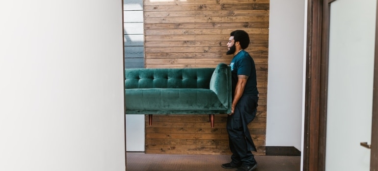 movers Vail carrying a sofa