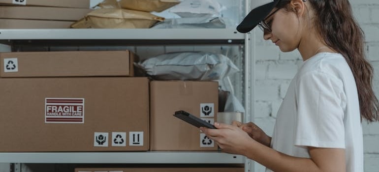a woman in a storage unit thinking about how to store ski gear