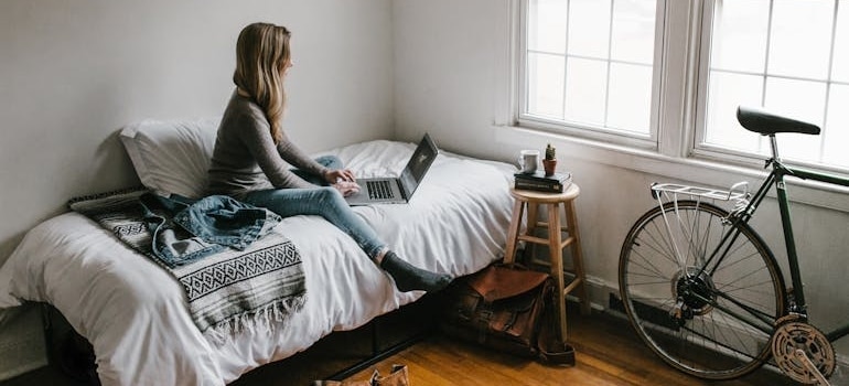 a woman browsing the net before relocating biking equipment