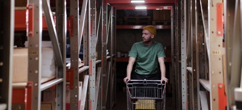 a man with a cart in a storage unit