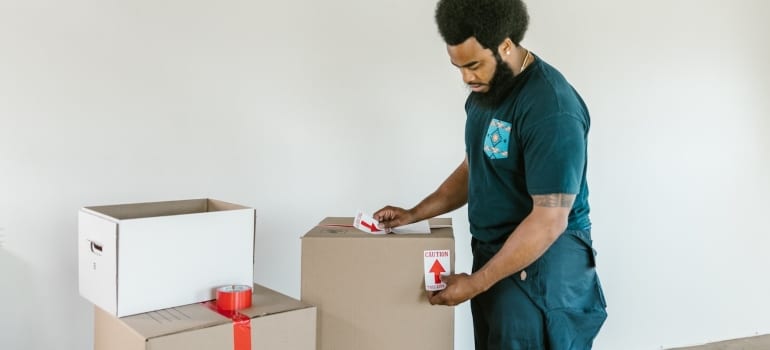 a mover packing a box