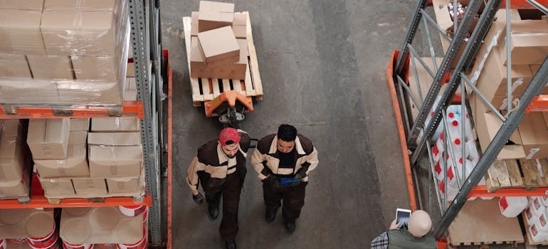 two men in a warehouse talking about storage rules and regulations in Colorado