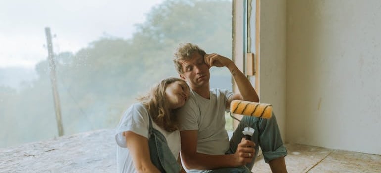 a couple making a break from weekend house restoration and remodeling