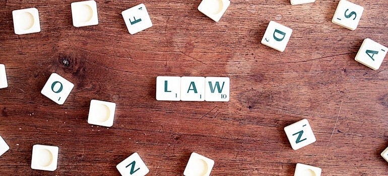 scrabble letters forming the word 'law'