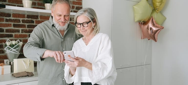 senior couple scrolling the phone