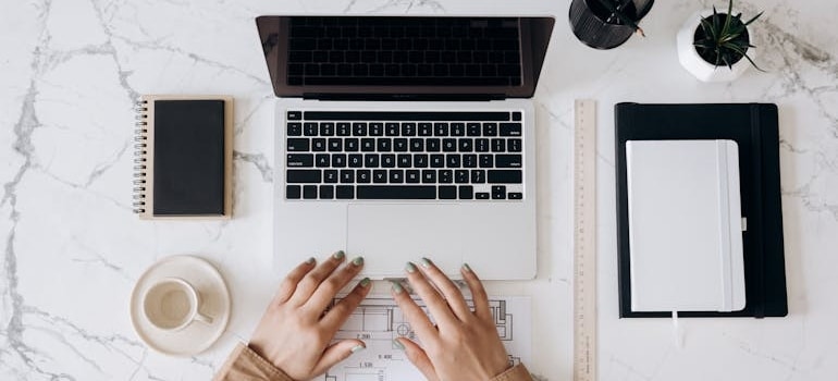 a person using a laptop to plan the relocation remotely